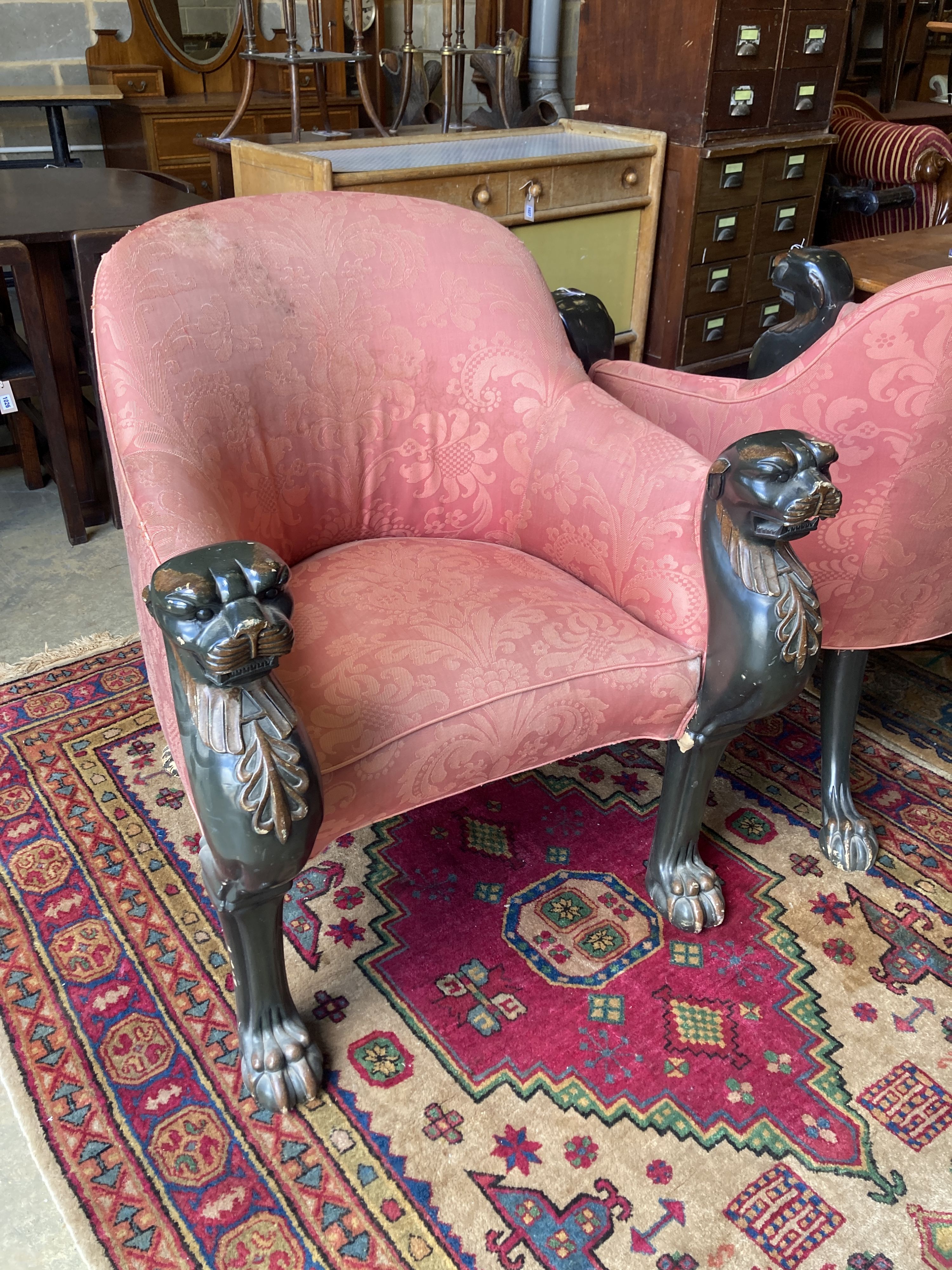 A pair of Empire style upholstered armchairs in the manner of Thomas Hope with leopards head terminals, width 80cm, depth 80cm, height